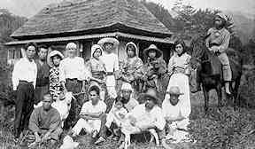 Posed photo of a group of 15 people in a rural setting